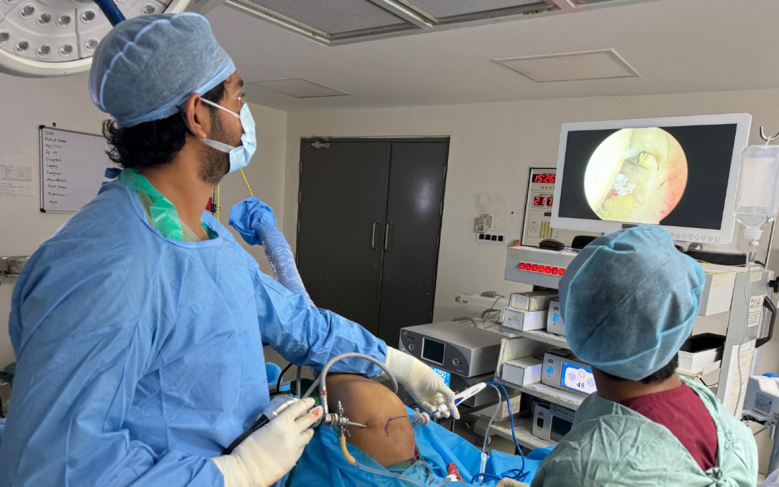 Dr. Arun Dev watching the surgical screen during knee surgery